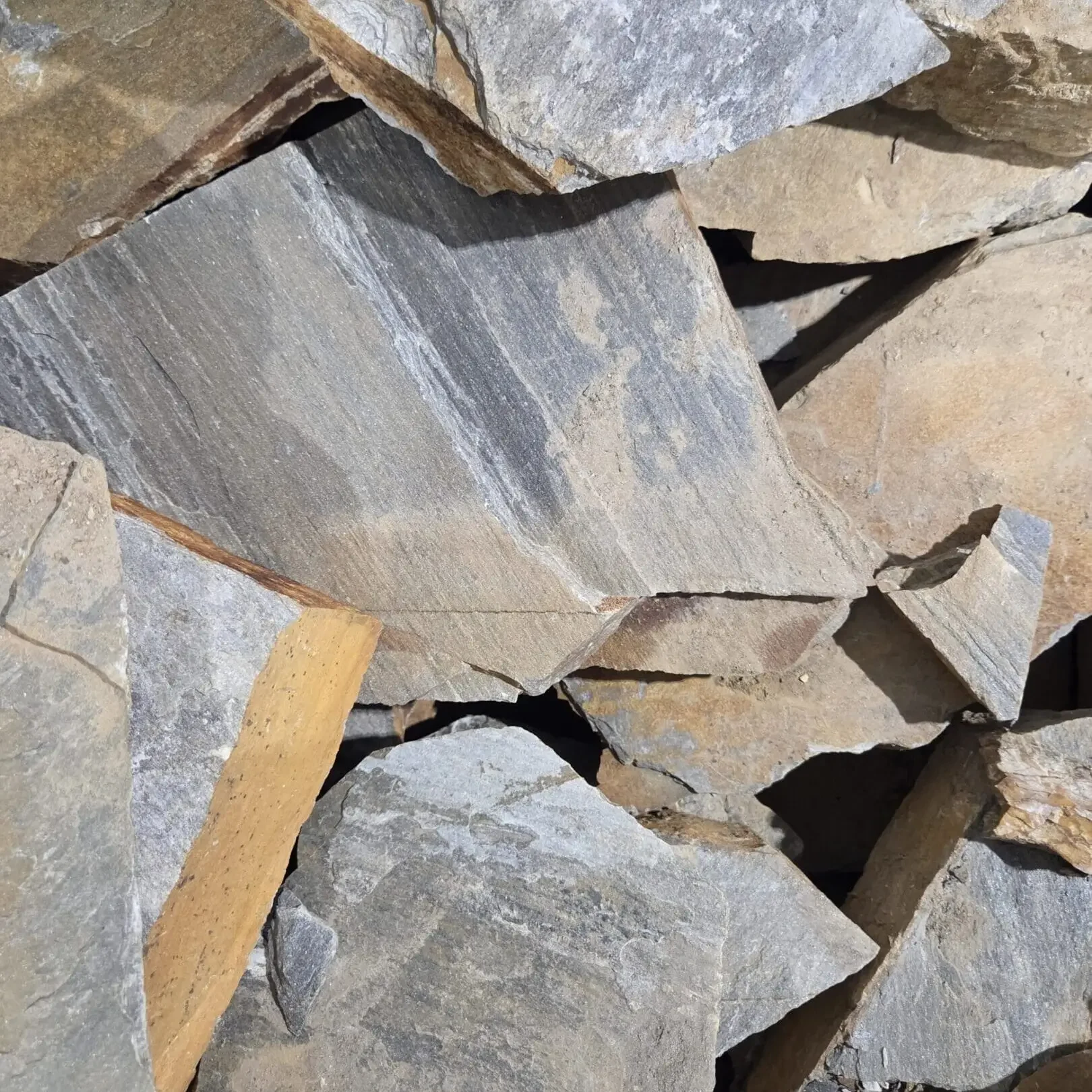 Stacked natural stones with rough texture.